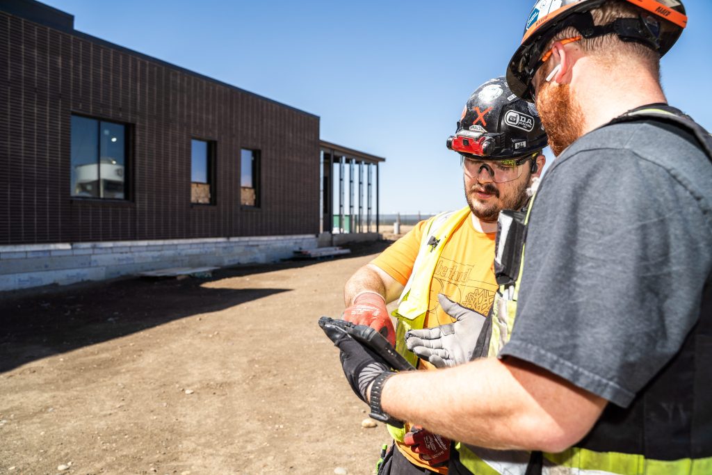 D.A. Electric crew reviewing plans on a job site