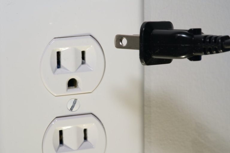 Electrical outlet and plug showing signs of a home electrical problem